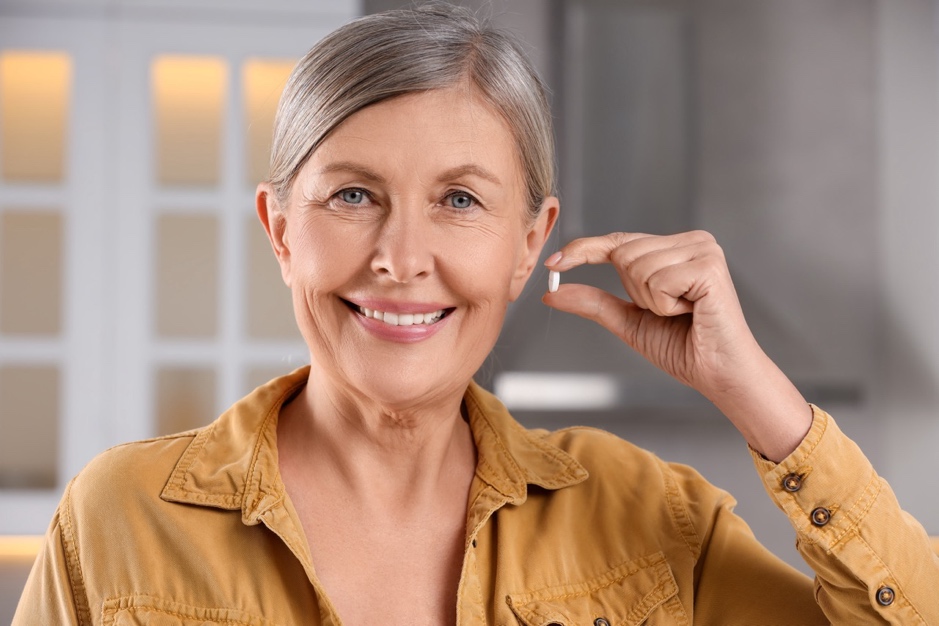 A woman holding a pill.