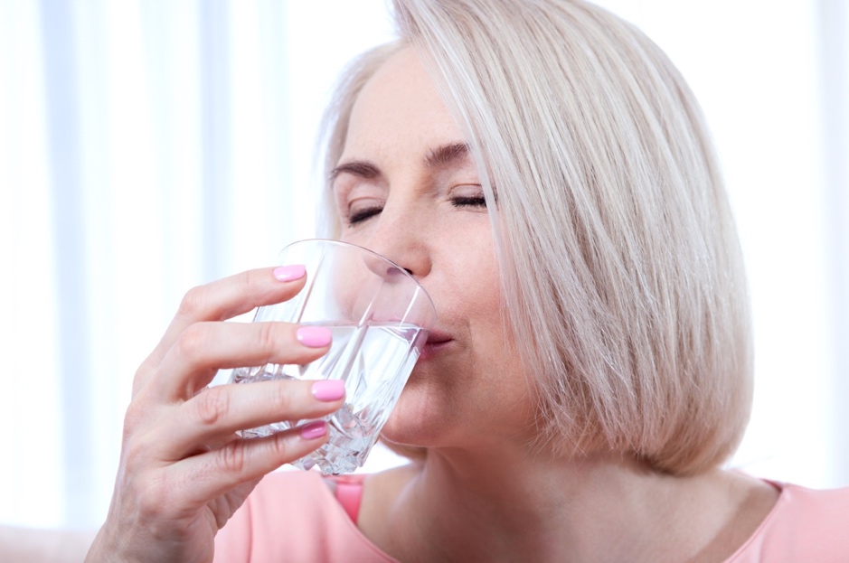 A person drinking water from a glass