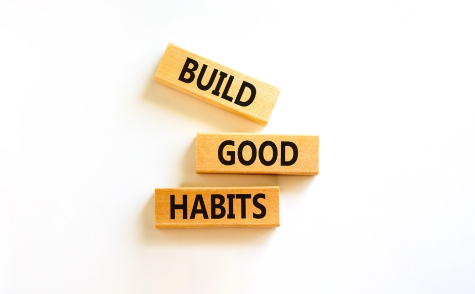 Wooden blocks with words on them saying build good habits