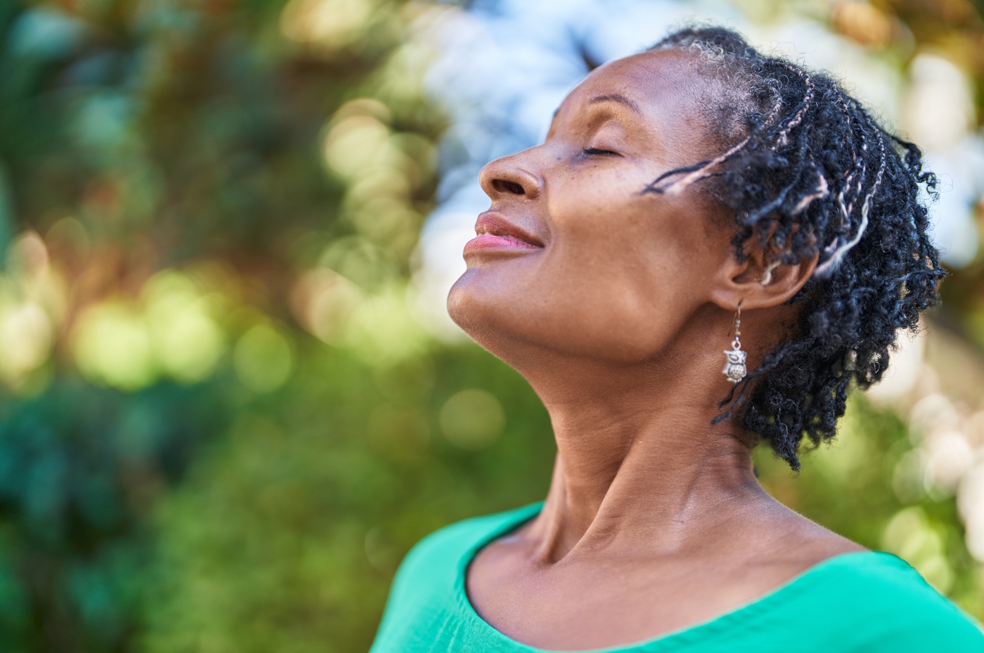 A person with her eyes closed meditating

