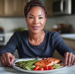 A person sitting at a table with a plate of food