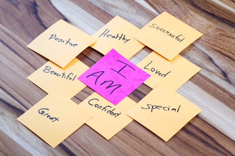 A group of sticky notes with positive words on them. I am successful, positive, beautiful, confident, great, special, loved.